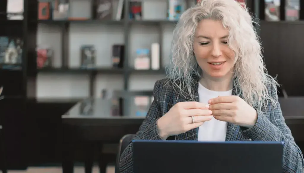 A Focused Designer Works Diligently In A Cluttered Yet Organized Modern Office. create design system with AI what-is an AI design system